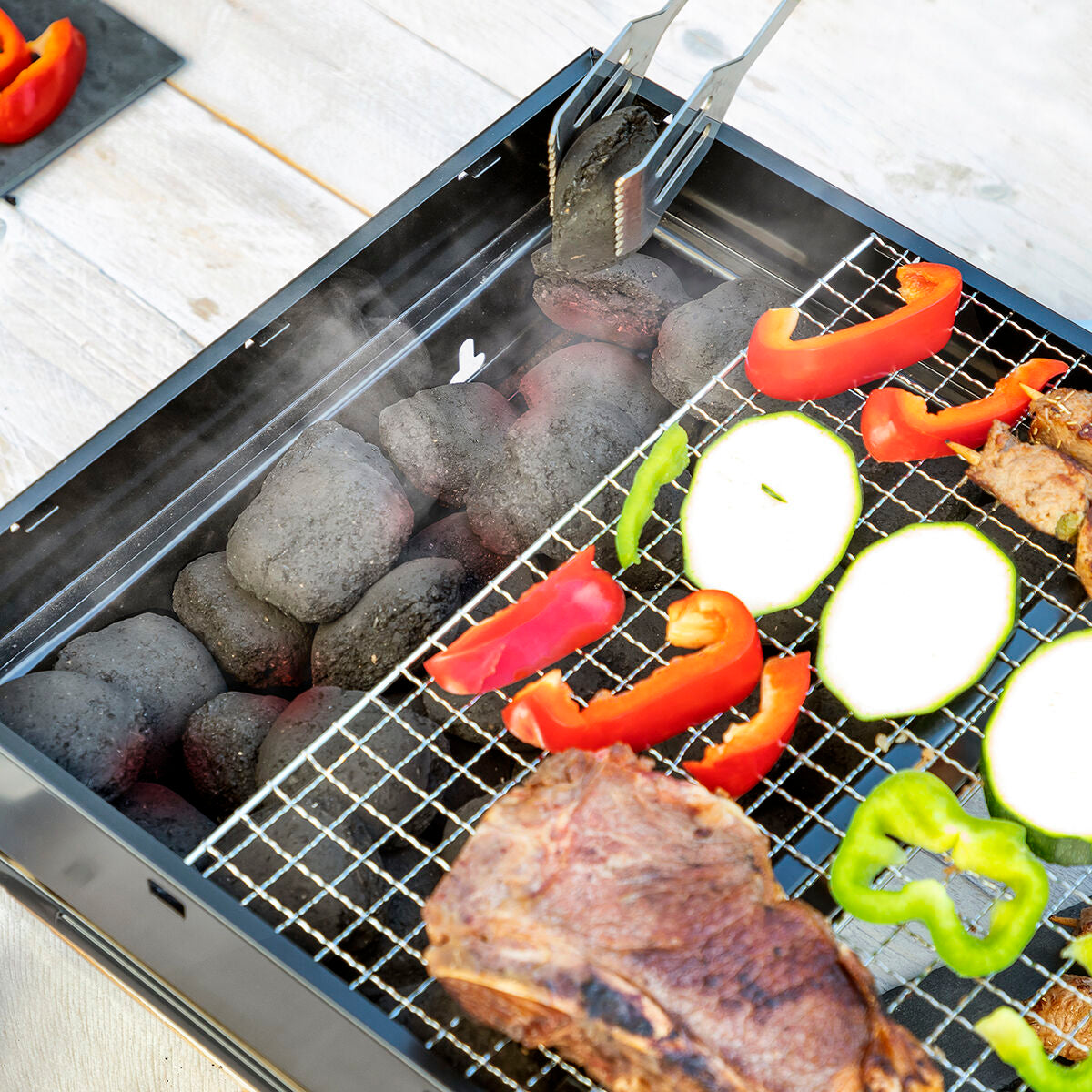 Foldable portable grill for use with charcoal 